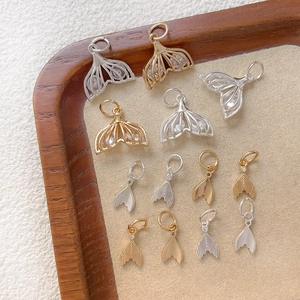 Hollow mermaid tail pendants with sparkling cubic zirconia in gold and silver plating