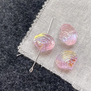 Close-up of pink iridescent shell glass beads for DIY jewelry with pearlescent finish