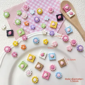 Close-up of colorful resin strawberry and sunflower beads for DIY jewelry making