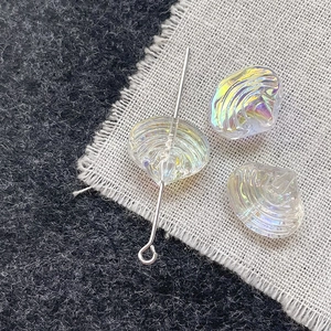 Macro shot of iridescent glass scallop beads with AB coating and silver metal pin