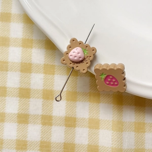 Detailed macro shot of a sweet cookie charm with strawberry design for DIY jewelry