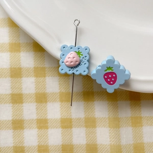 Detail of blue cookie-shaped strawberry beads for DIY jewelry making accessories