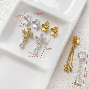 Detailed view of gold tassel flower and zircon cross pendants for jewelry DIY