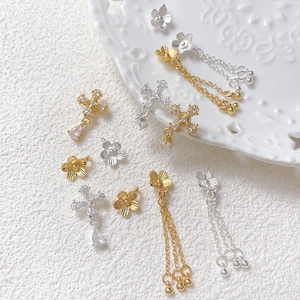 Gold plated flower and cross charms with zircon inlays and tassel chain details