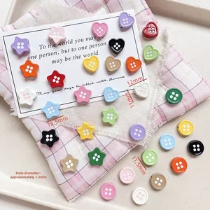 Detail of colorful button-shaped alloy beads in star and heart shapes for DIY crafts
