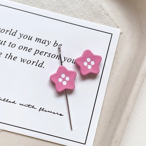 Close-up of pink star-shaped button beads with glossy enamel finish for DIY jewelry