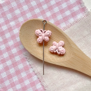 Pink butterfly bead with polka dots on a metal pin for DIY jewelry making