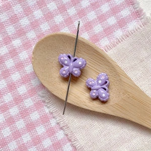 Macro shot of purple butterfly beads with polka dots for DIY jewelry making