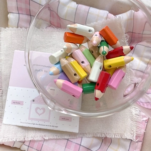 Macro shot of colorful mini pencil-shaped beads in a glass bowl for DIY jewelry making