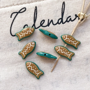 Close-up of tropical fish charms with striped pattern for DIY jewelry making