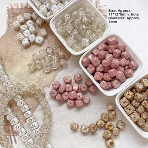 Detail of Czech glass beads with gold accents and marble patterns for DIY jewelry