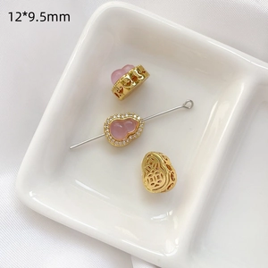 Detalle de cuenta de calabaza hueca bañada en oro con piedra rosa y medida 12*9,5mm