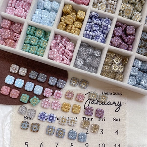 Macro shot of square vintage glass floral beads with hand-painted edges for DIY jewelry