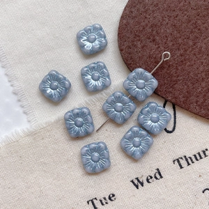 Macro detail of lavender Picasso glass flower beads with hole for DIY jewelry making