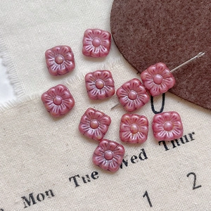 Macro detail of square Czech glass flower beads with vintage Picasso finish for DIY jewelry