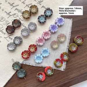 Macro shot of 14mm Czech glass flower beads with gold gilding for DIY jewelry making