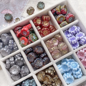 Close-up of colorful Czech glass flower beads with gold accents for DIY jewelry making