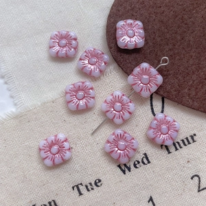Macro shot of pink gradient square floral glass beads for DIY jewelry making