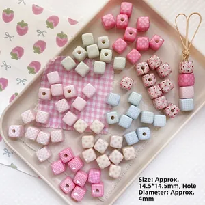 Detail view of 14.5mm square beads with heart and plaid patterns for DIY jewelry making
