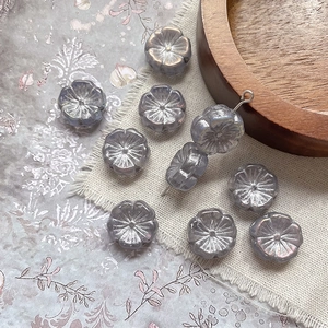 Macro detail of plum blossom glass beads with golden finish for jewelry making