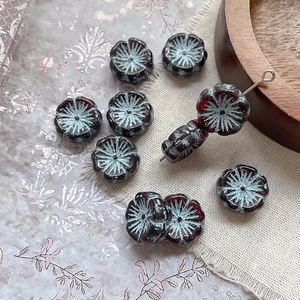 Macro detail of blue and reddish-brown flower beads for DIY jewelry making