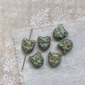 Macro view of vintage Czech glass cat head beads for DIY jewelry making