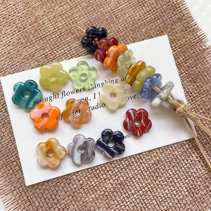 Macro shot of colorful marbled glass flower beads for DIY handmade jewelry crafting