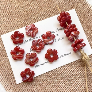Macro detail of red marble texture glass flower beads for DIY jewelry making
