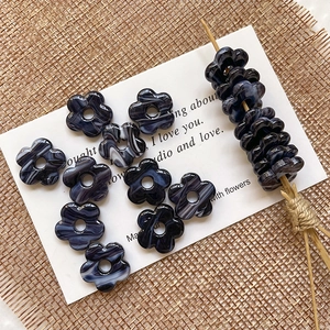 Macro shot of purple hollow flower beads with white marble texture for DIY jewelry making