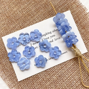 Macro detail of ice-blue hollow flower beads with marble texture for DIY jewelry
