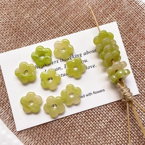 Detail of green flower beads with translucent texture for handmade DIY jewelry crafting
