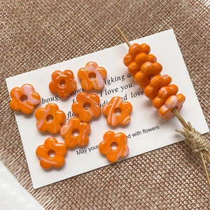 Macro detail of marbled orange glass flower beads for DIY jewelry making and crafts