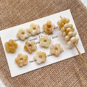 Macro detail of amber textured hollow glass flower beads for DIY jewelry making