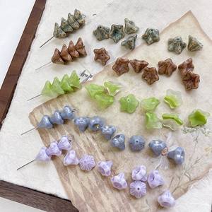 Close-up of vintage flower-shaped glass beads with artistic mottled glaze and textures