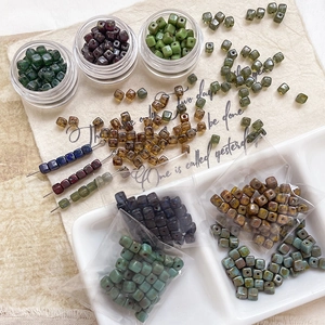 Macro detail of Picasso-style mottled glass cube beads for DIY jewelry making