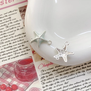 Détail macro de pendentifs étoile de mer en alliage avec doubles boucles pour DIY