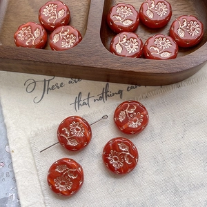 Macro shot of red and gold floral Margaret glass beads for DIY jewelry making