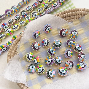 Macro shot of colorful evil eye glass beads with rainbow edges for DIY jewelry making