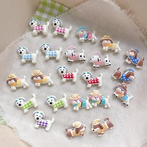 Macro shot of colorful resin puppy charms for DIY jewelry making and handmade crafts