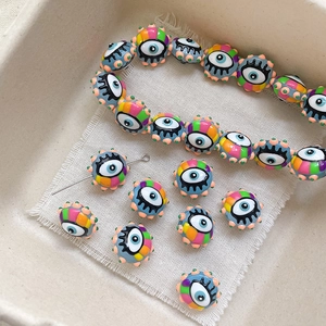 Detailed view of colorful evil eye handmade ceramic beads for DIY jewelry making sets