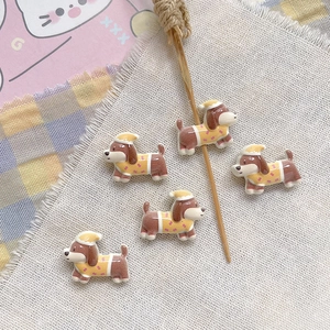 Detailed view of five cute resin puppy figurines with caps for DIY jewelry making