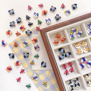 Colorful handmade ceramic bird and cat beads for DIY jewelry making in a wooden box