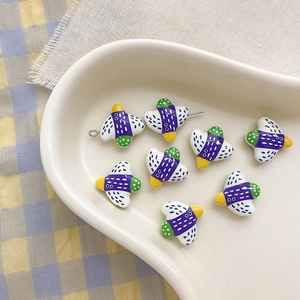 Detailed view of colorful bird-shaped alloy beads with polka dots for DIY jewelry making