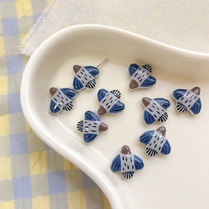 Detail of colorful bird-shaped ceramic beads with hand-painted patterns for DIY jewelry making
