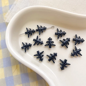 Close-up of deep blue Christmas tree beads with snowflake dots for DIY jewelry making