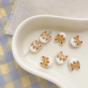 Macro shot of cute cat-shaped ceramic beads for DIY handmade jewelry crafting