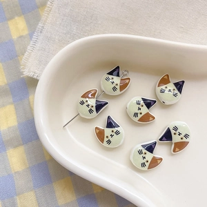 Detailed view of colorful calico cat enamel beads for DIY jewelry and handmade crafts