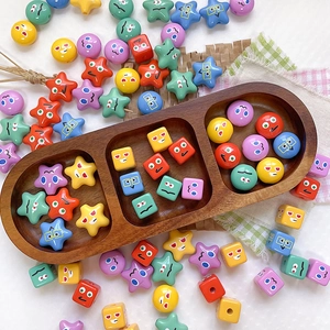 Close-up of colorful cartoon expression beads in various shapes for DIY jewelry making