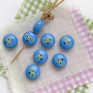 Macro shot of blue beads with yellow glasses print for DIY handmade jewelry crafts