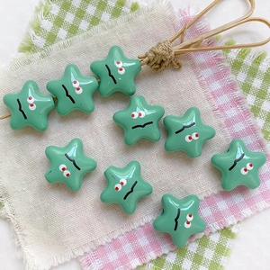 Star-shaped mint green beads with cartoon faces and holes for DIY jewelry making